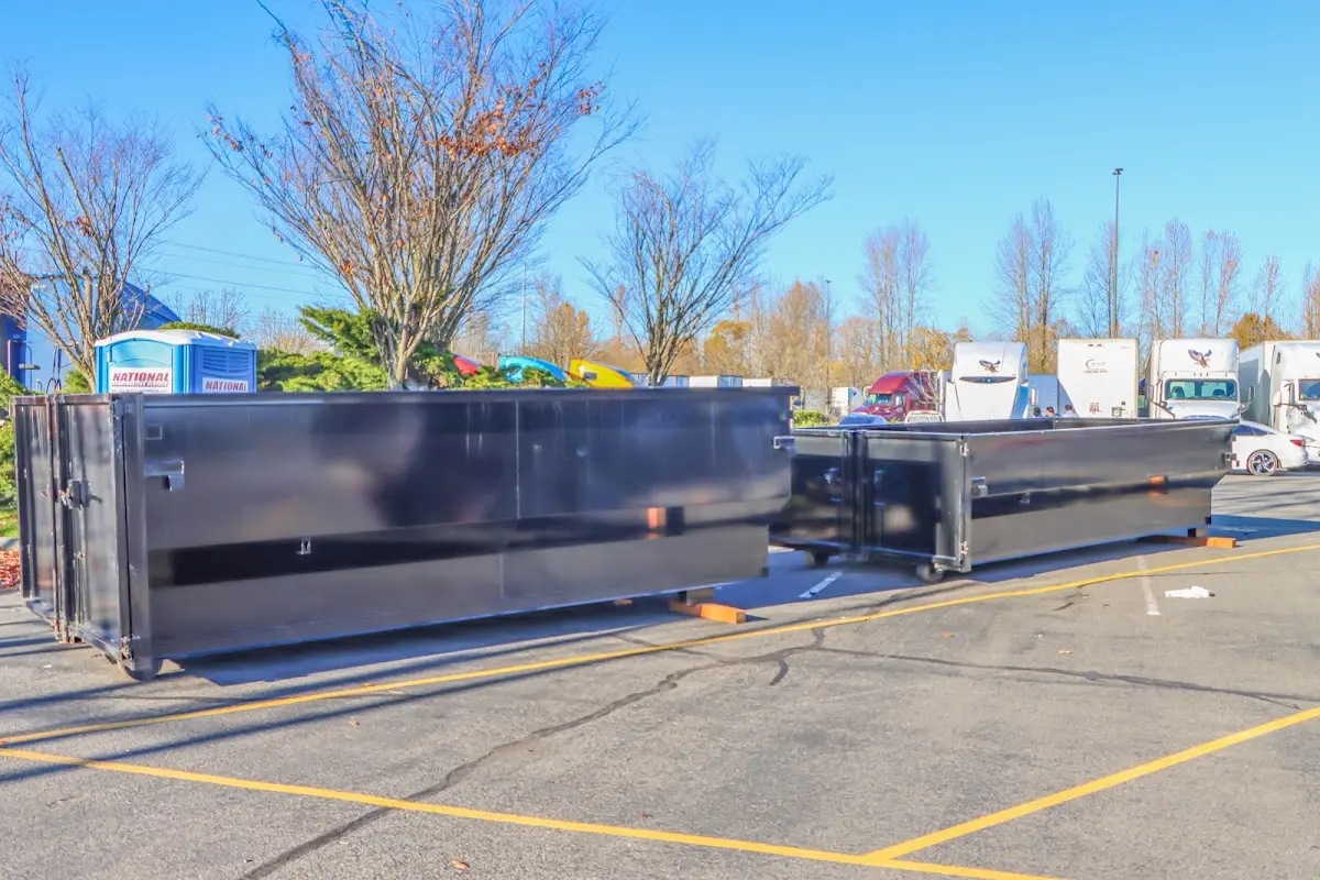 Professional dumpster rental service with roll-off container on residential driveway in Rittman